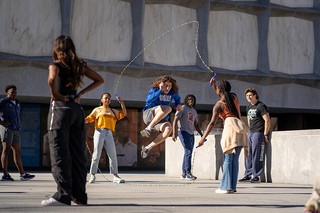 Students jumping rope in front of Beinecke Library