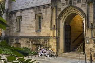 Arched doorway of campus building with bicycles locked up beside it