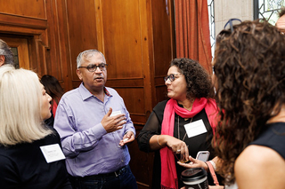Group of attendees standing together in discussion during the 2024 PLC Fall Gathering