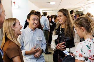 Group of attendees standing together in discussion during the 2024 PLC Fall Gathering